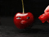 a cherry with a face on it being eaten
