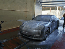 a car is being washed with foam and a license plate that says ' a ' on the back