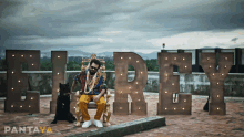 a man sitting on a throne with a dog in front of a sign that says ' el rey '