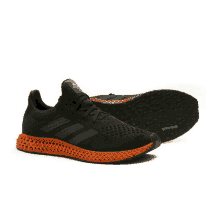 a pair of black and orange adidas shoes with continental rubber