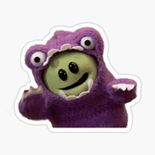 a purple monster with a green smiley face on its face