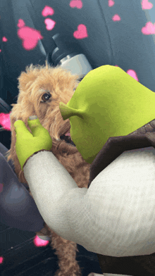 shrek kissing a small brown dog with pink hearts behind them