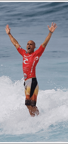 a man in a rip curl shirt is riding a wave in the ocean