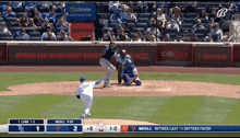 a baseball game is being played in front of an official fan to fan ticket market sign