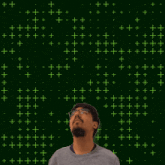a man is looking up at the number eight on a green background