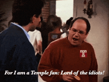 a man in a red sweater with the letter t on it says " for i am a temple fan lord of the idiots "