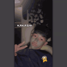 a man with a mask on his face has kakashi written on the bottom right