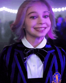a girl with pink hair is wearing a striped jacket with the letter n on the front