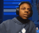 a boy wearing headphones looks surprised in front of a screen that says " voice options "