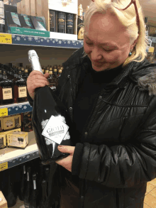 a woman holds a bottle of gioli wine