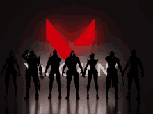 a group of people standing in front of a red icon that says ' ninja '