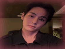 a close up of a person 's face with a pink background behind them