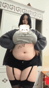 a woman with a large belly has a sticker on her belly that says palya