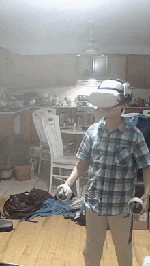 a young boy wearing a virtual reality headset holds a controller