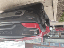 a red ram truck is parked upside down on the street