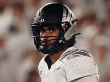 a football player wearing a black and white helmet with the letter o on it