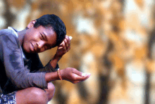 a young boy with a bracelet on his wrist is holding something in his hand