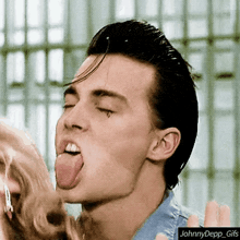 a close up of a man sticking his tongue out with the words johnny depp gifs below him
