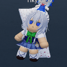 a doll with white hair and blue eyes is sitting on a pillow with the name tiky written on the bottom