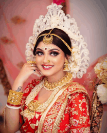 a woman in a red and gold dress with a crown on her head is smiling for the camera