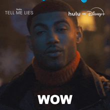 a close up of a man 's face with the word wow written on it