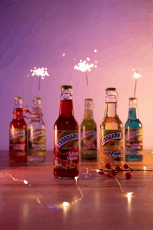 bottles of tymbark are on a table with sparklers