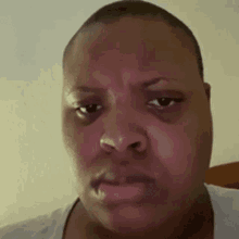 a close up of a person 's face with a sad look on their face .