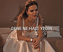 a woman in a white dress is sitting on a bed with the words gene ne halt yedin written above her
