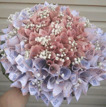 a person is holding a bouquet of money that says 500 on it