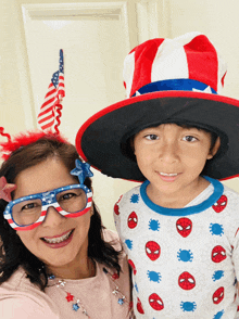 a woman and a boy wearing patriotic hats and glasses pose for a picture