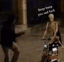 a skeleton is riding a motorcycle with a man standing behind him .