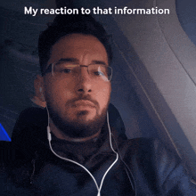 a man wearing glasses and ear buds is sitting on an airplane with the caption " my reaction to that information "