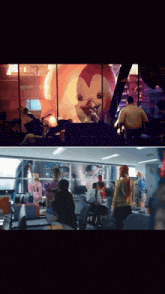 a group of people are gathered in a room with a penguin on a wall