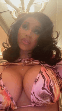 a woman with very large breasts is wearing a bikini top