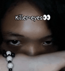 a close up of a woman 's face with the words killer-eyes written above it