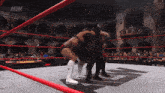 two wrestlers in a ring with aew on the bottom