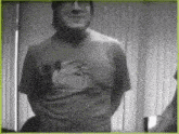 a man wearing a t-shirt with a picture of a bird on it