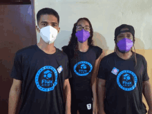 three people wearing flux army shirts and masks