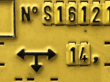 a yellow sign with the numbers n o s1612 and 14 on it