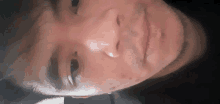 a close up of a man 's face with his eyes open