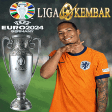 a soccer player stands in front of a trophy that says euro2024 on it