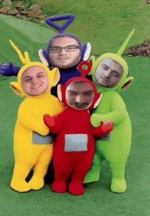 a group of people dressed in teletubbies costumes with their faces on them