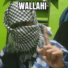 a person wearing a scarf on their face with the word wallahi written on it