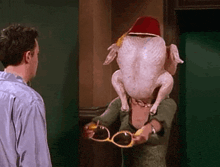 a man and a woman are standing next to each other with a turkey on their head .