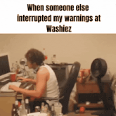 a man sits at a desk with the words when someone else interrupted my warnings at washiez on the bottom