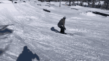 a person is riding a snowboard down a snowy hill