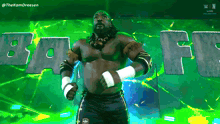 a wrestler is standing in front of a green background with the word baff on it