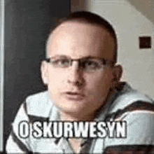 a man wearing glasses and a plaid shirt is making a funny face and saying oskurwesyn .