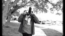 a black and white photo of a man wearing a mask and a t-shirt with a mickey mouse on it