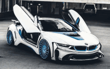 a white and blue bmw is parked in a parking garage